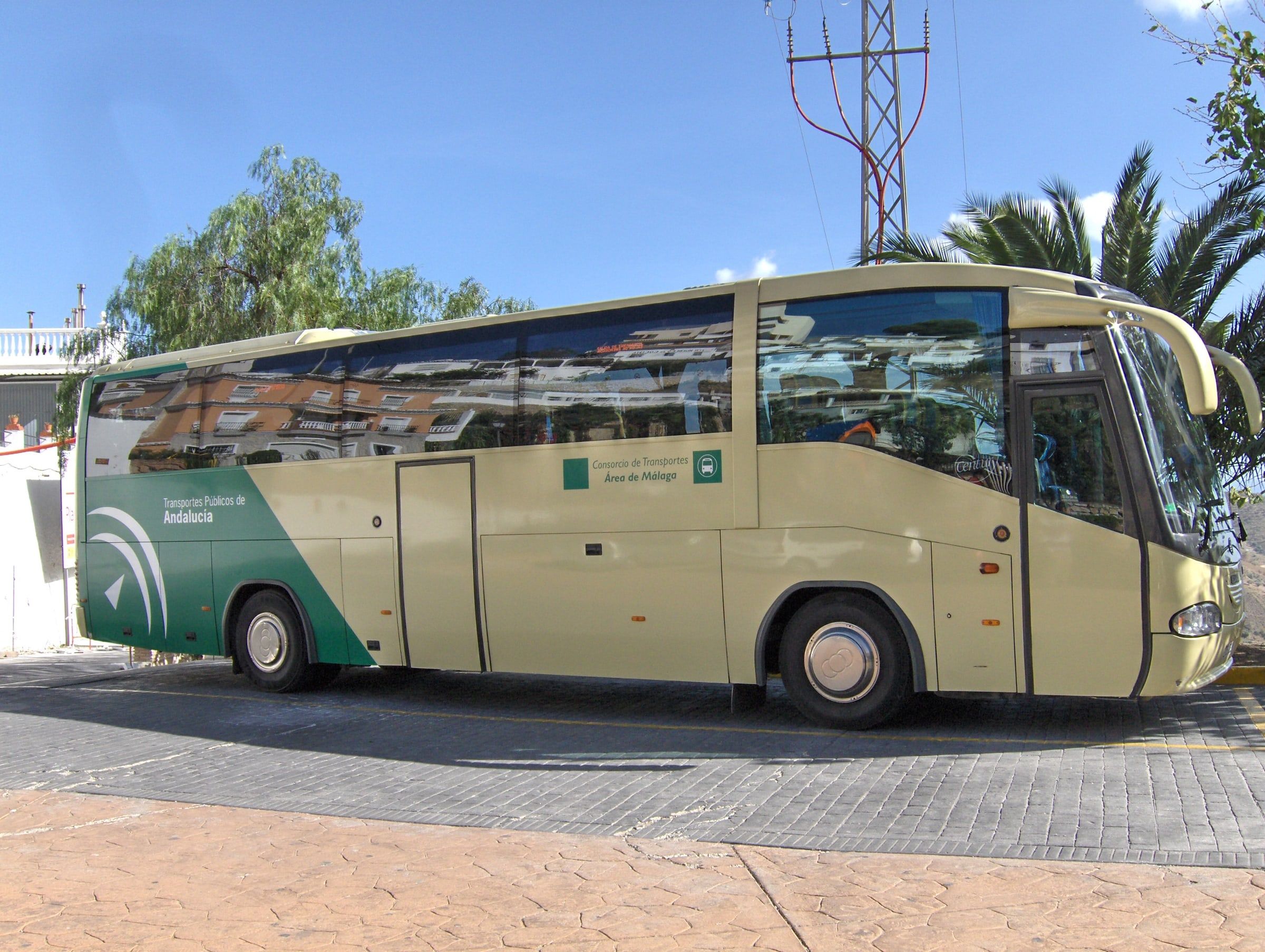 Autobús interurbano verde y crema del Consorcio de Transportes del Área de Málaga aparcado en Moclinejo, en la Axarquía